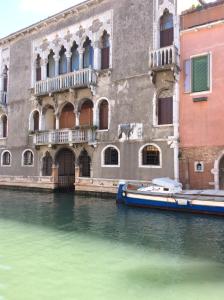 a boat in the water in front of a building at Appartamento con vista in Venice