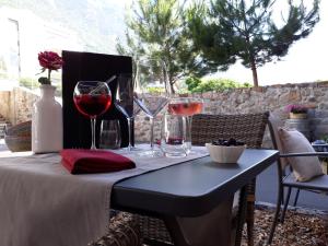 a table with glasses of wine on a patio at Hôtel de Fully in Fully