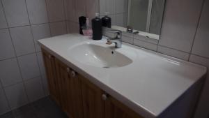 a bathroom with a white sink and a mirror at Jækta Fjordstue in Mosvik +9 photos