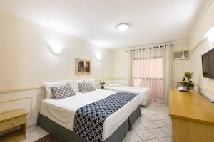 Кровать или кровати в номере Hotel Guarany