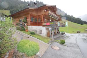 a large wooden building on the side of a mountain at Rimmlhof & Rimmlstube in Berwang