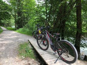 two bikes are parked on a wooden bridge at Branderhof in Jochberg