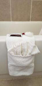 a towel that is on the edge of a bath tub at Super 7 Motel in Sedalia