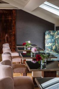 a row of tables and chairs with flowers on them at Vista Palazzo - Small Luxury Hotels of the World in Como
