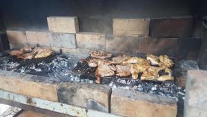 a group of chickens cooking on a grill at Apartmani Košuta in Tjentište