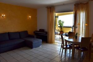 a living room with a couch and a table at Taormina Sunny Apartment - Taormina Holidays in Taormina