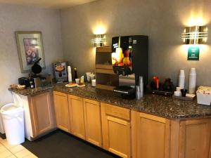 a kitchen with a counter with a refrigerator at Americas Best Value Inn Cedar City in Cedar City