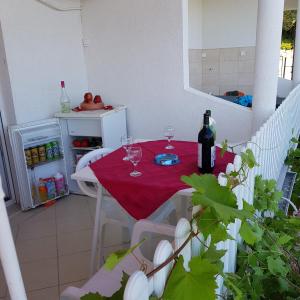 a table with two glasses of wine on a balcony at Apartments Draga in Budva +39 photos