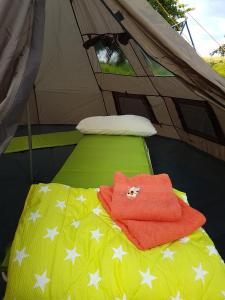 a bed in a tent with a towel on it at Eternahof in Bad Gandersheim