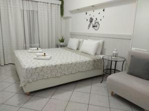 a bedroom with a bed with a table and a couch at Neapoli Rooms in Neapoli Voion