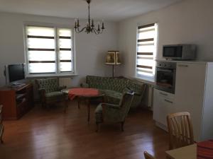 a living room with a couch and a table at Ferienwohnung Amanda in Stützerbach