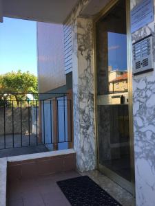 a front door of a house with a glass door at Casa Smeraldo in Loano