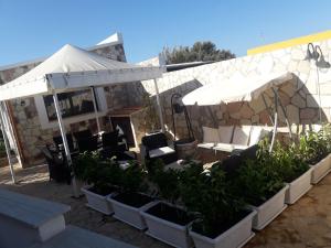 a restaurant with tables and chairs under an umbrella at Villa Lucia in Lampedusa