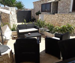 a group of chairs and tables on a patio at Villa Lucia in Lampedusa