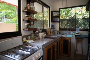 a small kitchen with a stove and a sink at Casa del Sol in Tamarindo