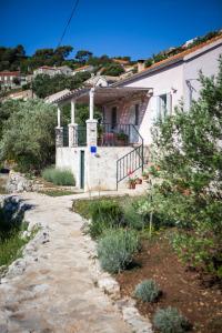 a house with a stone path leading to it at TEUTA Holiday house in National Park in Goveđari