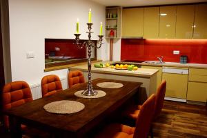a kitchen with a wooden table with candles on it at Sunshine Dreams Villa Jahorina in Jahorina