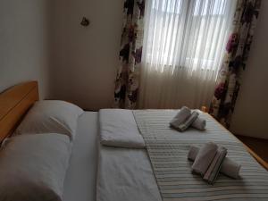 a bedroom with a bed with two towels on it at Pansion Bojic in Međugorje