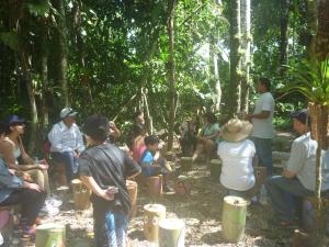 a group of people sitting around in the forest at Hospedaje Las Amazonas in Iquitos