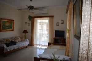 a living room with a couch and a tv at Villa Anna Alykes in Alykes