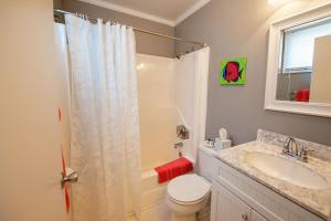 a bathroom with a shower and a toilet and a sink at Adams Ocean Front Resort in Dewey Beach
