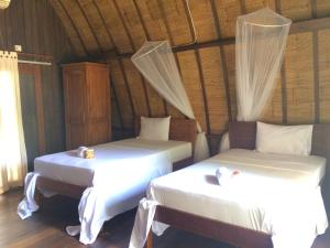 Postel nebo postele na pokoji v ubytování Melati Cottage