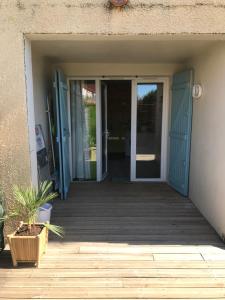an open door of a house with a porch at Résidence Village Marin Catalan TORREILLES PLAGE in Torreilles