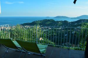 einen Balkon mit 2 Stühlen und Meerblick in der Unterkunft LA CASTELLANA Una Finestra sul Mare- Air Conditioned in Lerici