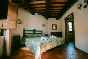 a bedroom with a bed with towels on it at I Casali Di Colle San Paolo in Tavernelle