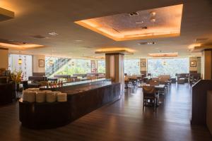 a restaurant with a bar and tables and chairs at Cedarwood Villa in Tai'an