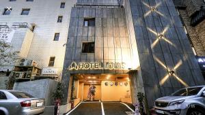 a hotel building with a sign on the front of it at Hotel Louis in Busan