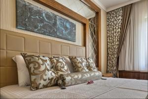 a couch sitting on top of a bed in a room at City Hotel Residence in Ankara