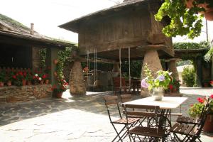 a patio with a table and chairs and flowers at Casa Mario in Posada de Rengos