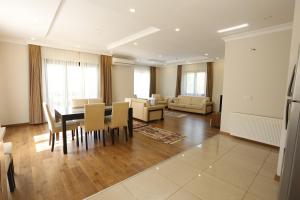 a dining room and living room with a table and chairs at Guzel Evler Family Resort in Sapanca +57 photos