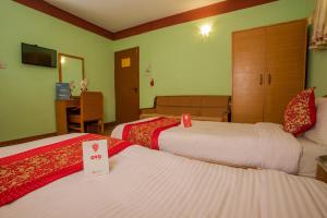 Postel nebo postele na pokoji v ubytování Hotel Green Orchid