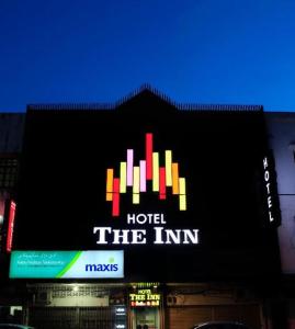 a building with a sign that reads hotel the inn at The Inn Hotel in Kuala Terengganu