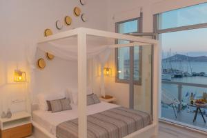 A bed or beds in a room at Naxos Riviera Suites