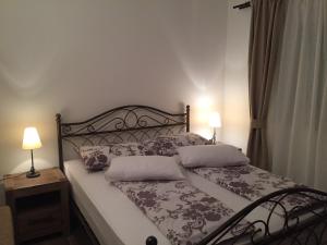 a bedroom with a bed with two pillows on it at Villa Rosana in Rab