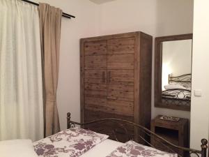 a bedroom with a bed and a dresser and a mirror at Villa Rosana in Rab