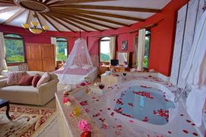 a living room with a tub in the middle of a room at Ephesus Boutique Hotel in Kirazli