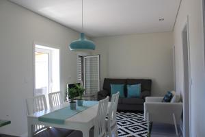 a living room with a table and a couch at Vivenda Mendes 2 in Vila Nova de Famalicão