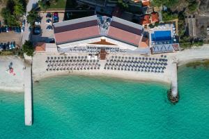an aerial view of a building over the water at Ammon Zeus Luxury Beach Hotel in Kallithea Halkidikis