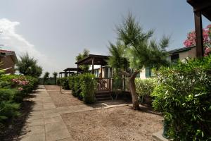a house with a tree in front of it at Villaggio Diomedea in Campomarino