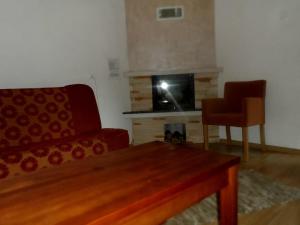 a living room with a red couch and a fireplace at Leśna Ryba in Jedlanka Stara