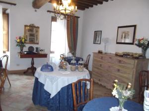 a dining room with a table and a dresser at L'Arcadia in Pietrasanta