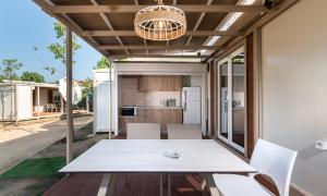 a kitchen and dining room with a table and chairs at Camping Tsitreli in Kalamitsi