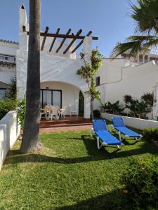 a green lawn chair sitting in front of a patio at Apartamentos Perla Marina in Nerja