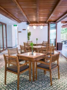 a dining room with wooden tables and chairs at Vinh Hung Old Town Hotel in Hoi An