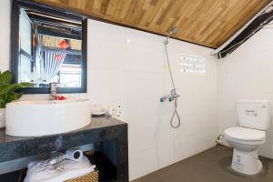 a bathroom with a sink and a toilet at An Bang Stilt House Villa in Hoi An +102 photos