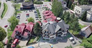 an overhead view of a large house with pink roofs at Willa Ponikiewka in Międzybrodzie Bialskie